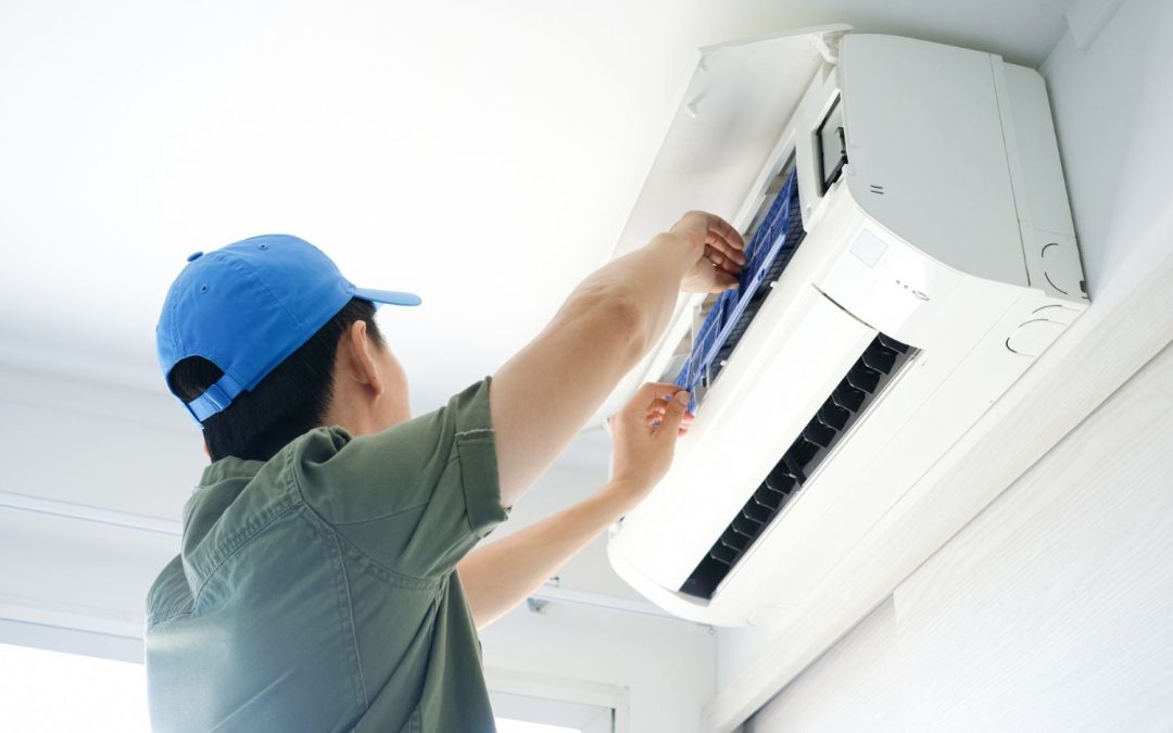 HVAC technician servicing a ductless mini split in San Mateo