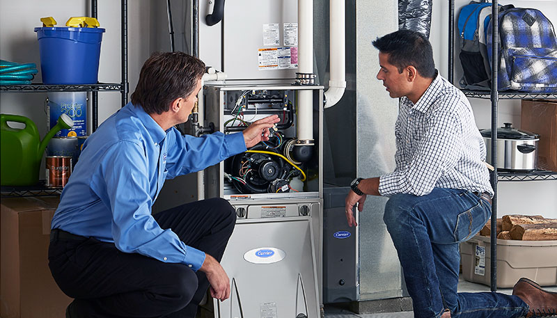 Technician evaluating a furnace for repair or replacement in San Mateo