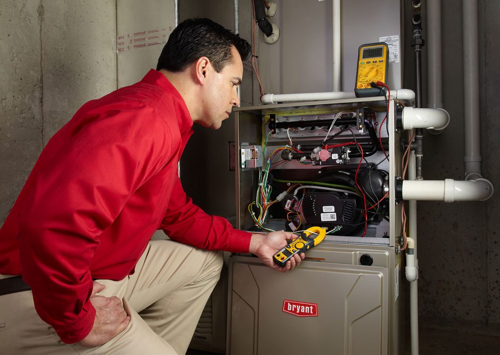 Heating technician diagnosing a furnace repair in San Mateo