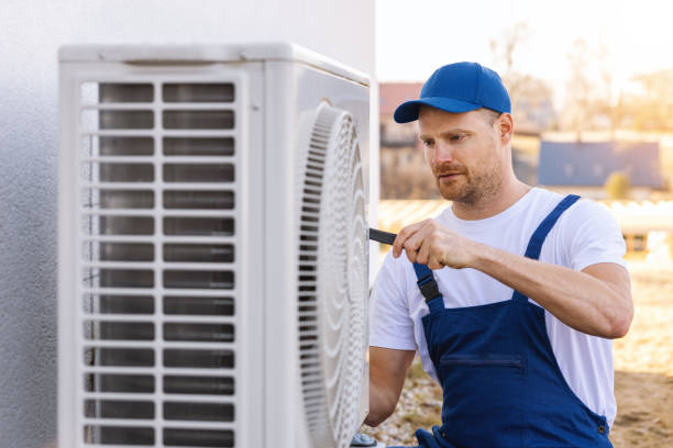 HVAC technician servicing an outdoor air conditioner in San Mateo