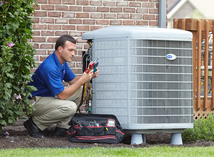 HVAC technician inspecting an outdoor AC unit in San Mateo