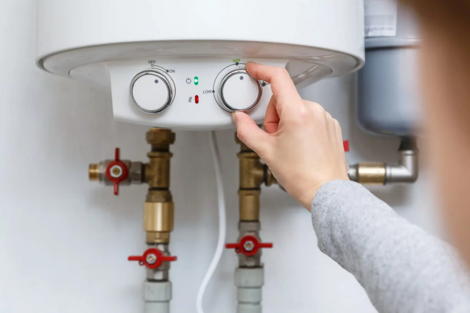 Technician adjusting a water heater in San Mateo